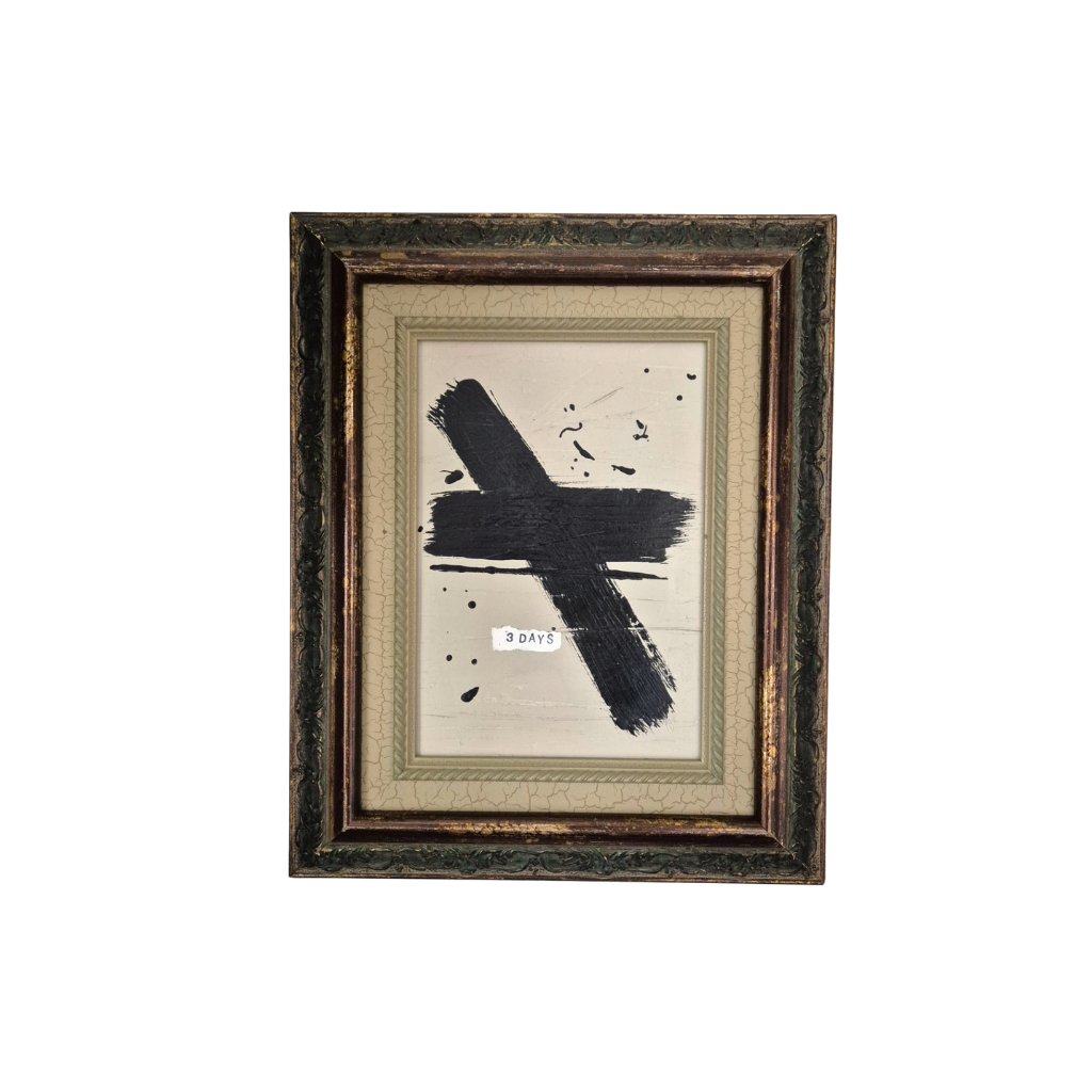 Framed abstract artwork with a black brushstroke on a white background