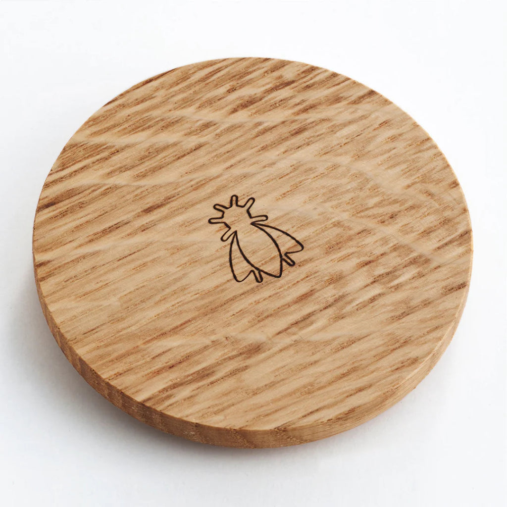 Wooden coaster with a engraved design on a white background