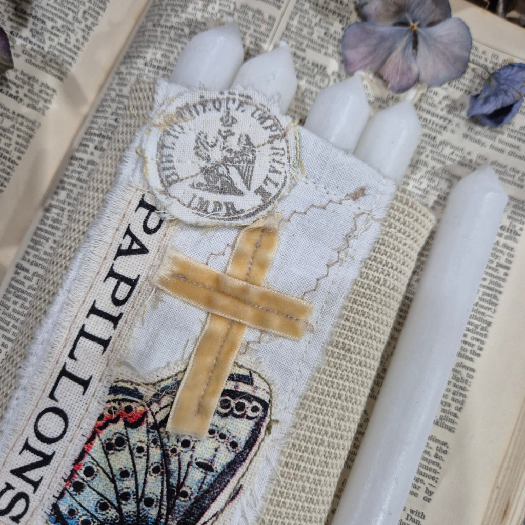 Decorative bag with butterfly design on a textured surface with Candles