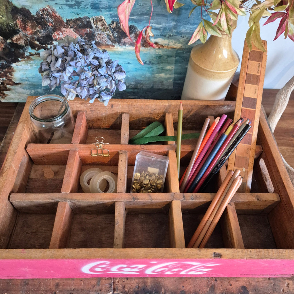 Wooden desk organizer with stationery items against a rustic background
