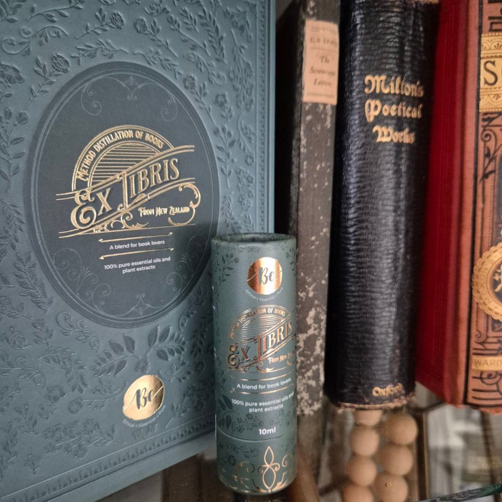 Stack of books with a cylindrical object featuring branding on top