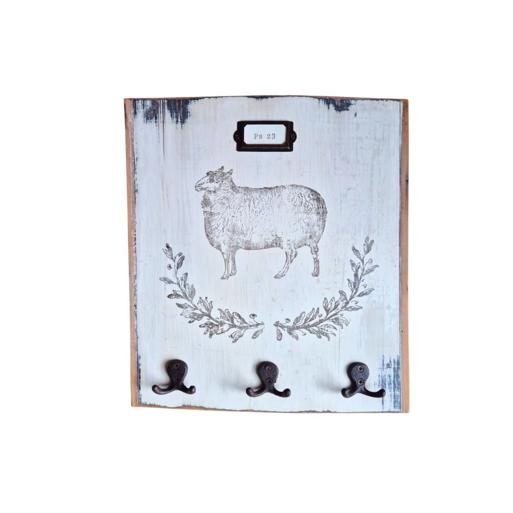 Decorative wall hook with sheep design and three hooks on a white background