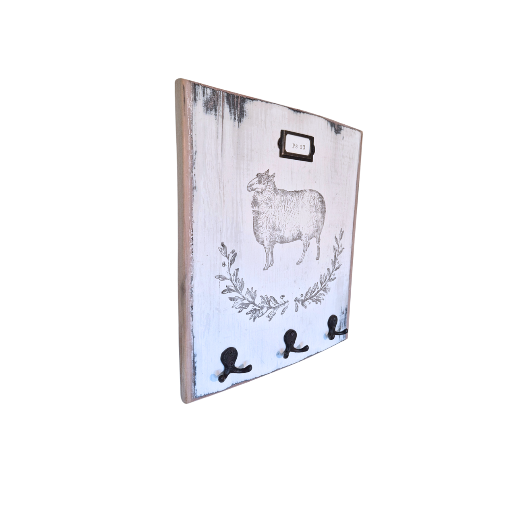 Decorative wall hook with sheep design on a white background