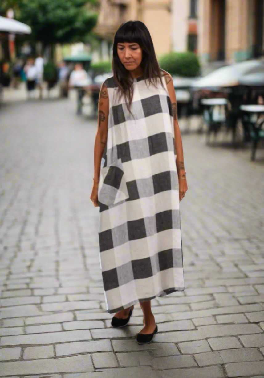 Woman wearing a checkered dress on a white background