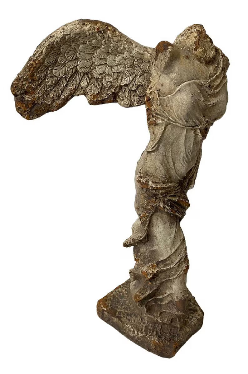 Statue of an angel with outstretched wings on a white background