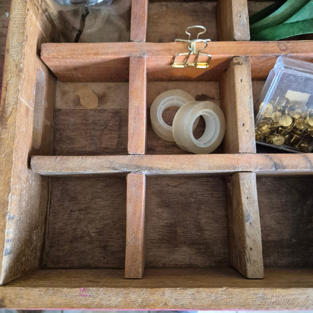 Wooden box with compartments containing tape and clips