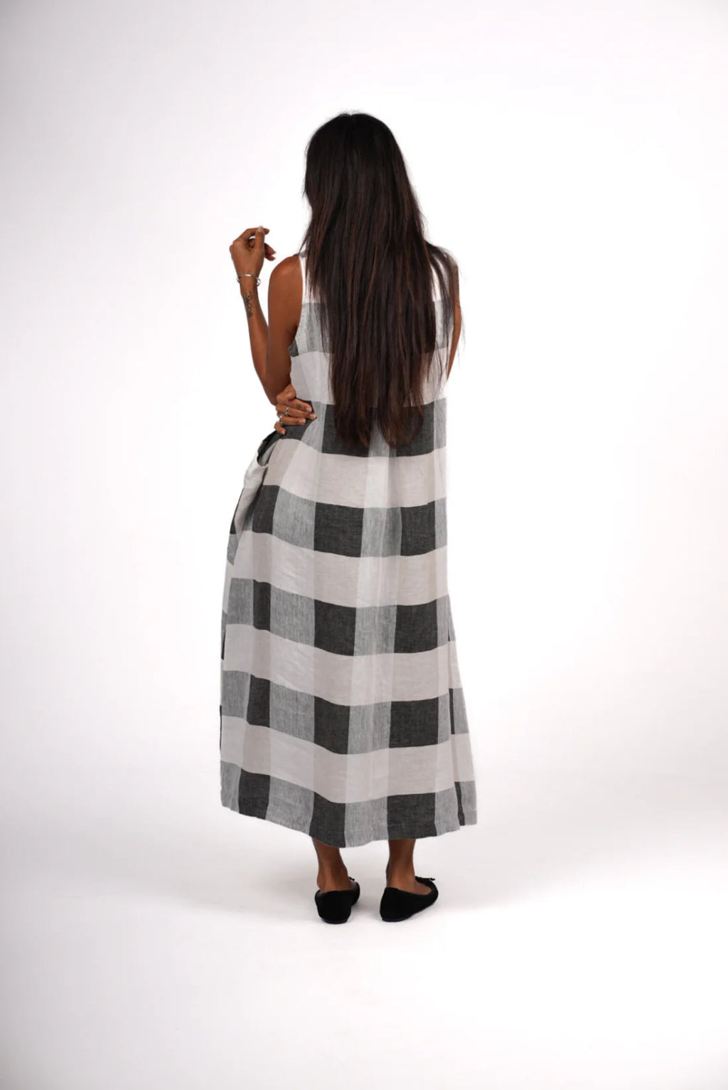 Woman wearing a black and white checkered dress on a white background