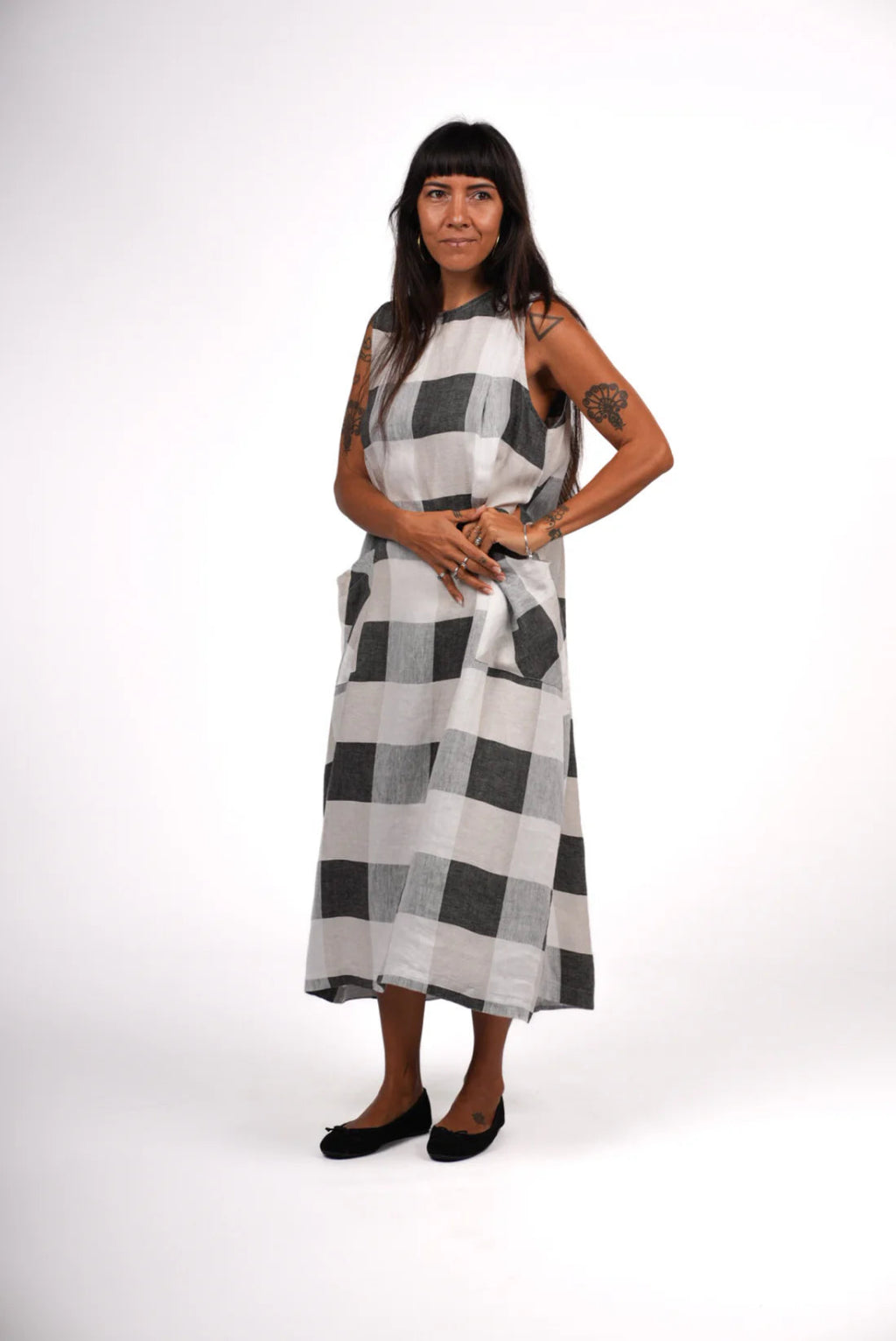 Woman wearing a black and white checkered dress on a white background