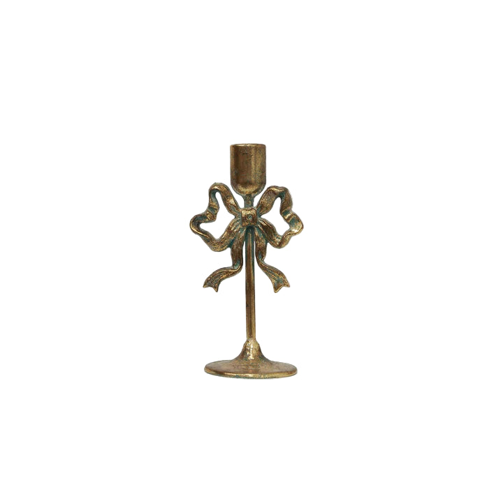 Decorative candle holder with bow design on a white background