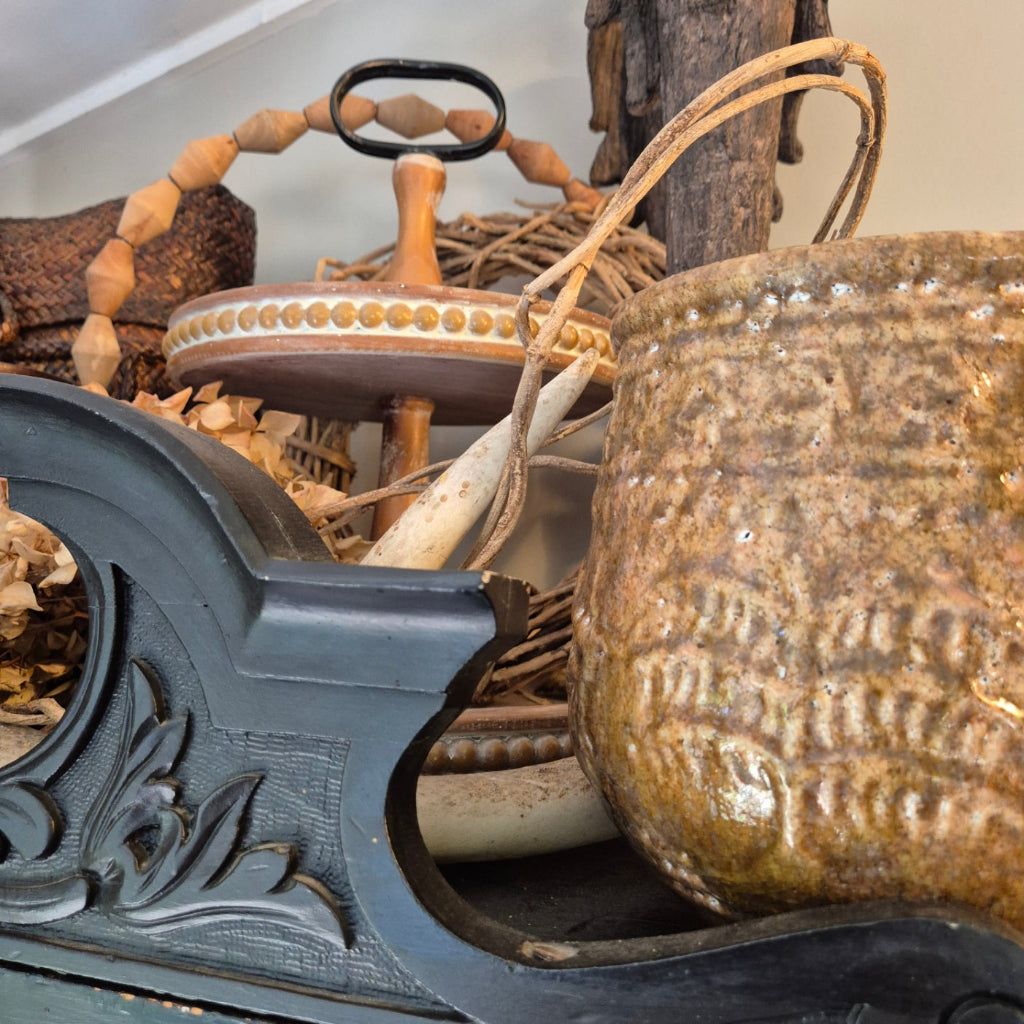 Close-up of a rustic metal and wood object with intricate details.