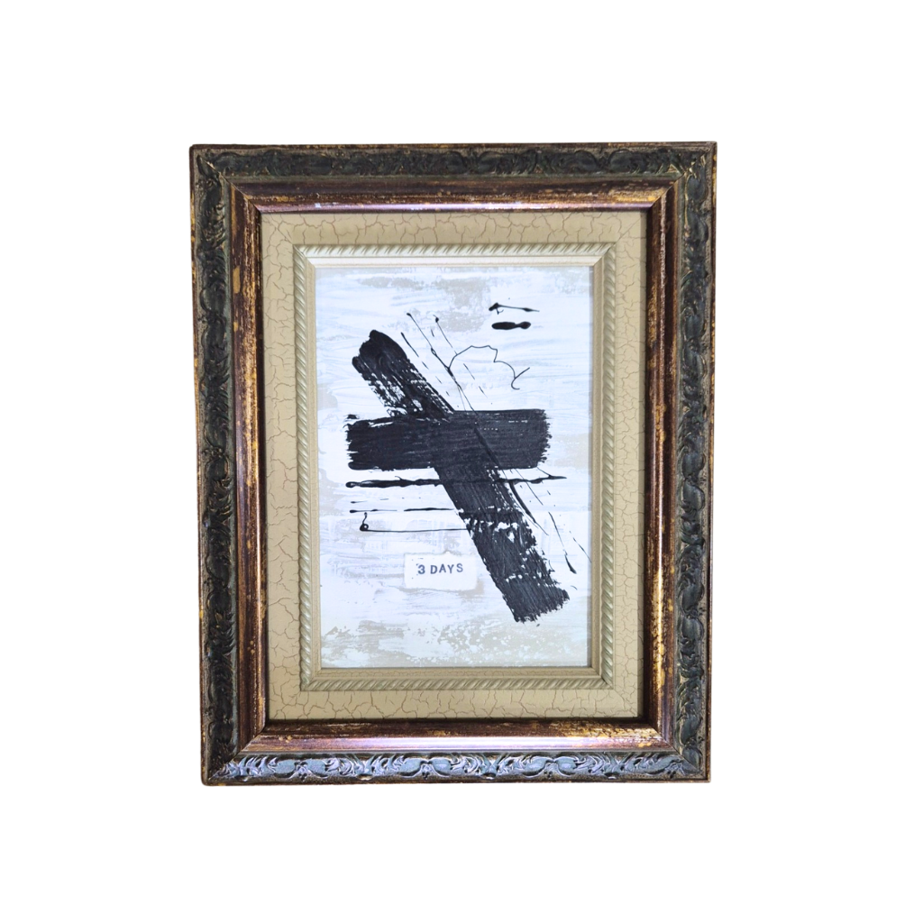 Framed artwork with a black cross on a white background