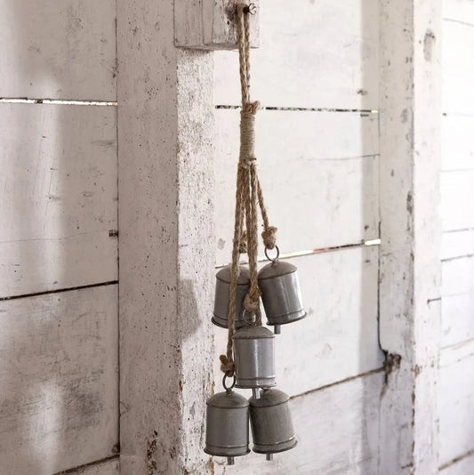 Set of 5 metal buckets hanging on a wooden wall