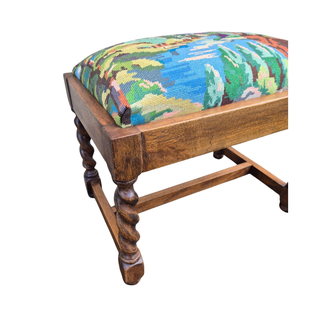 Oak Wooden stool with a colorful needlepoint cushion on a white background