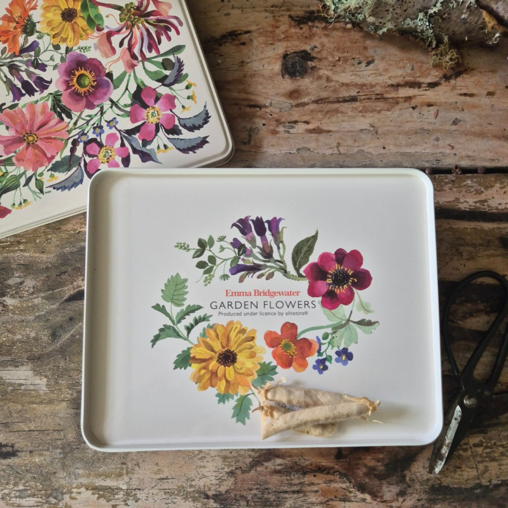 Floral-themed tin box on a wooden surface