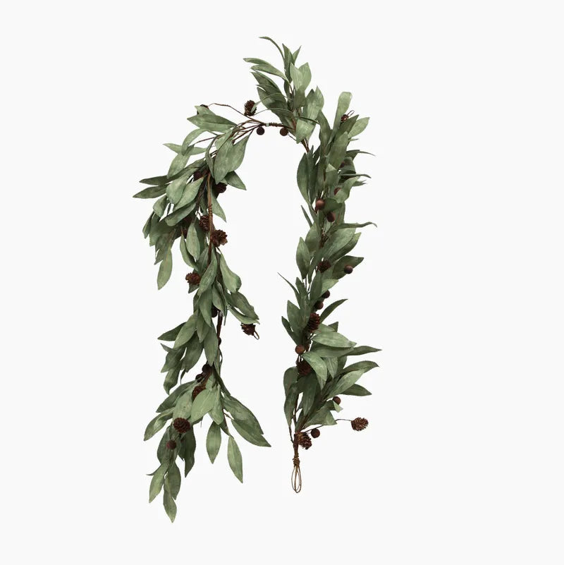 Green leafy garland with small cones on a white background