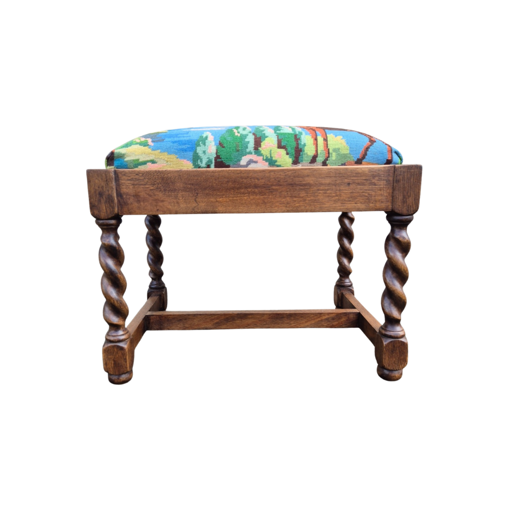 Wooden stool with a colorful cushion on a white background