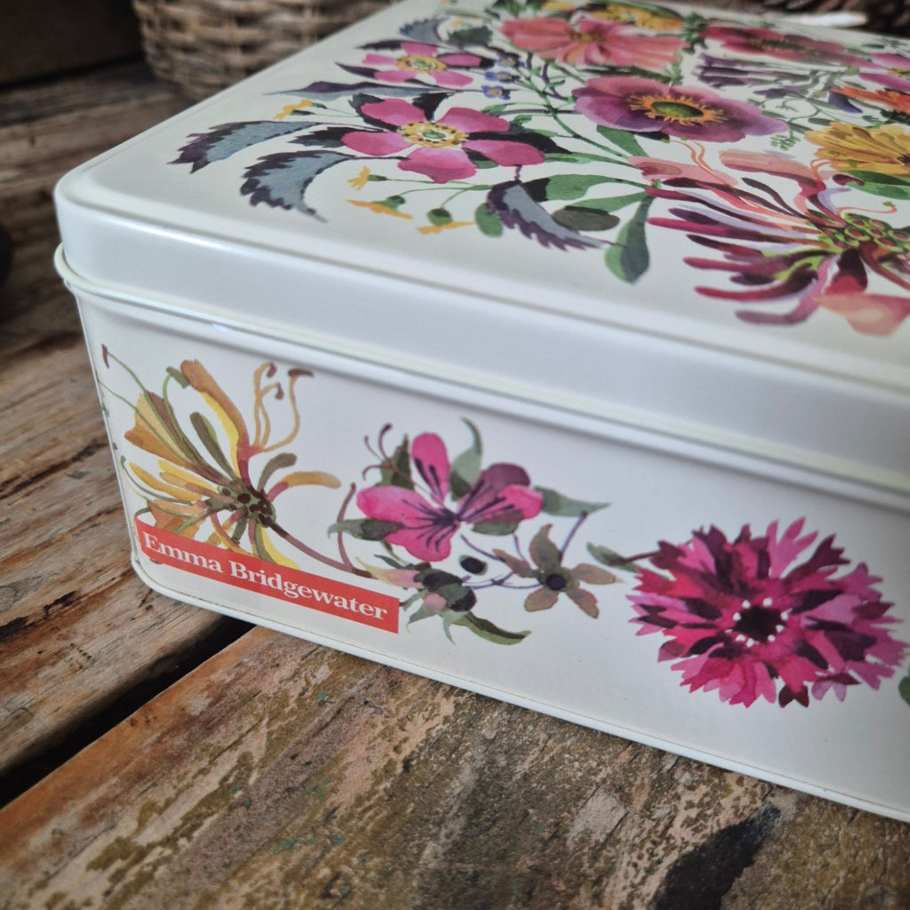Floral-patterned metal tin on a wooden surface