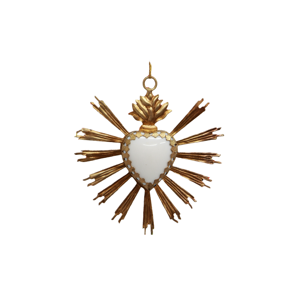 Decorative heart ornament with gold rays on a white background