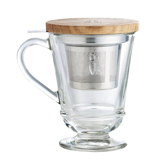 Clear glass mug with wooden lid and metal tea infuser on a white background