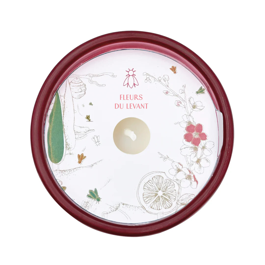 Round container with floral design and 'Fleurs du Levant' branding on a white background