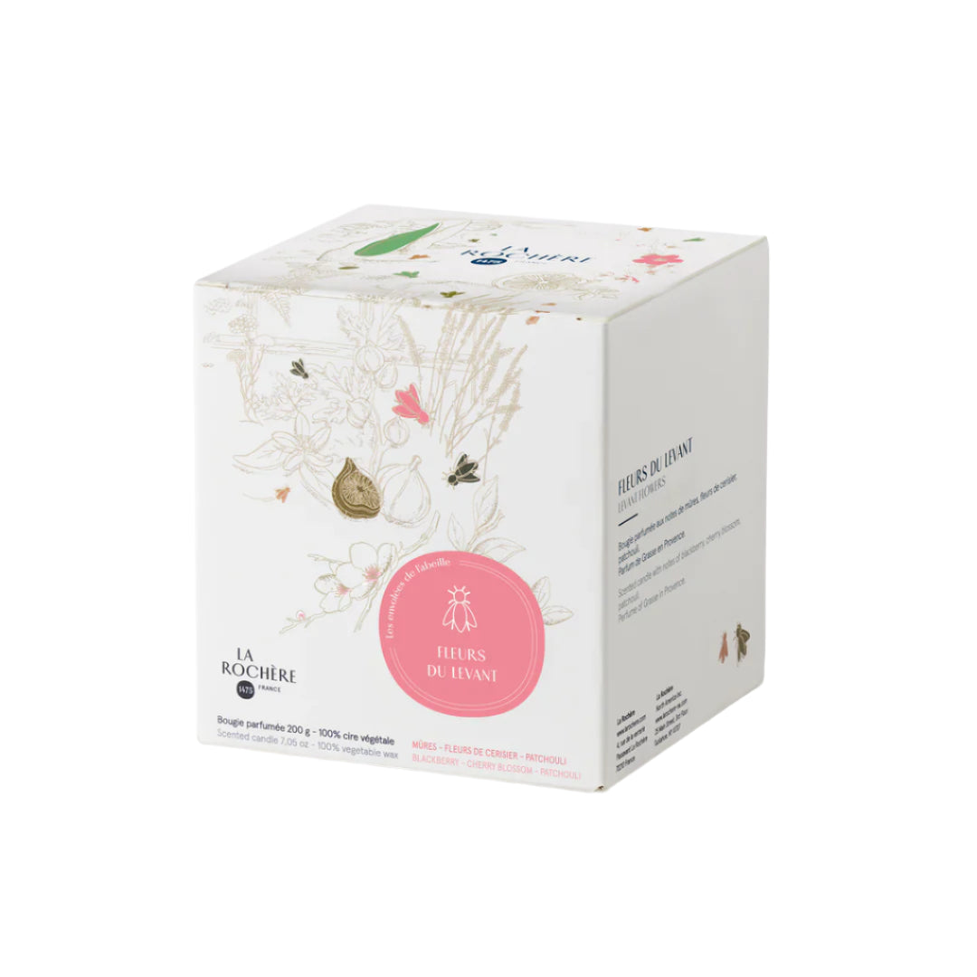 Candle box with floral design and pink label on a white background