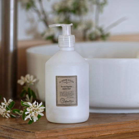 White bottle with pump on a wooden surface with blurred background