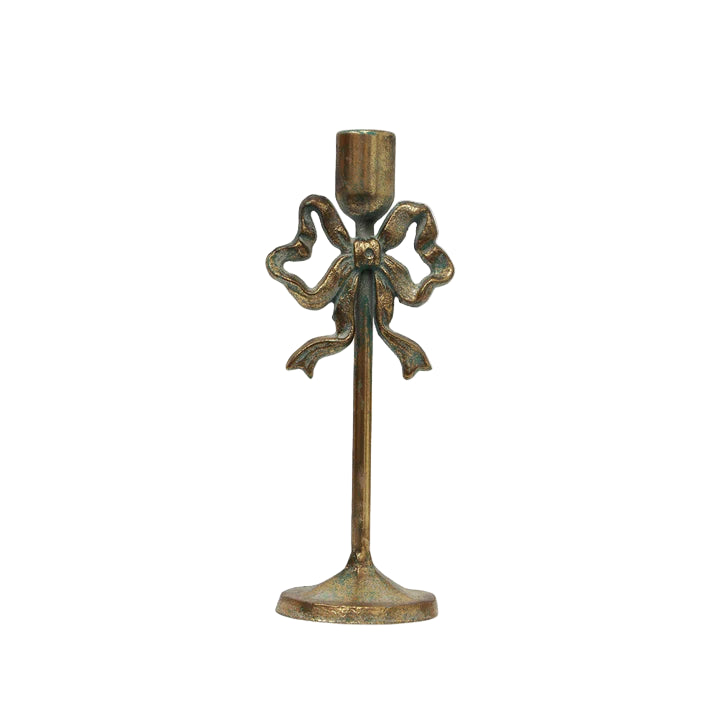 Bronze candle holder with decorative bow design on a white background