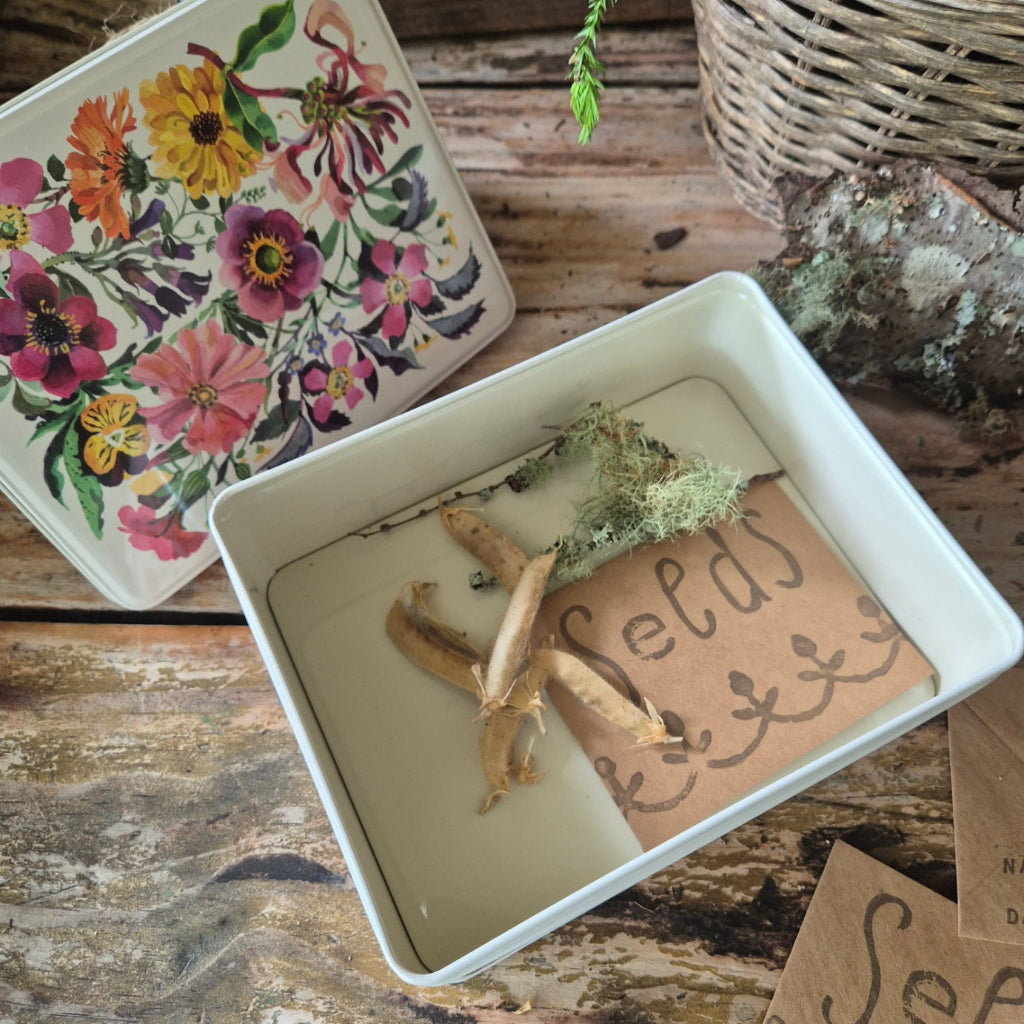Decorative items including a star-shaped object, moss, and a floral card on a wooden surface.