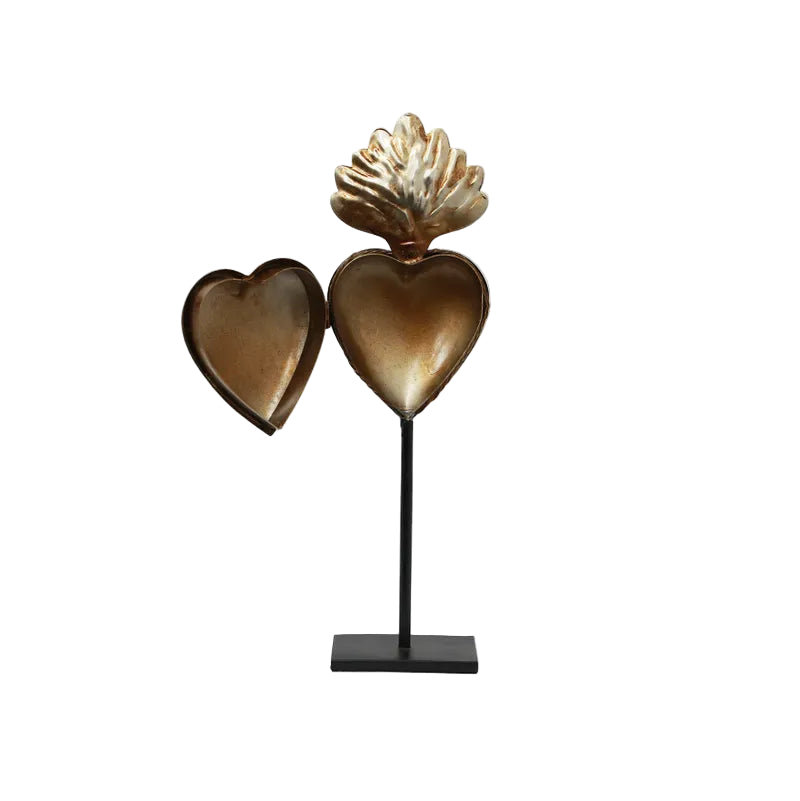 Decorative sculpture of two hearts on a stand with a white background
