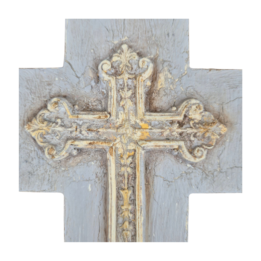 Decorative cross with gold detailing on a textured gray background