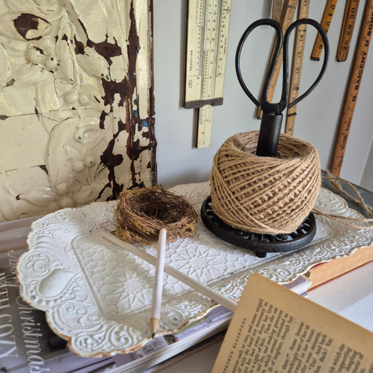 String and scissors Holder on white metal tray