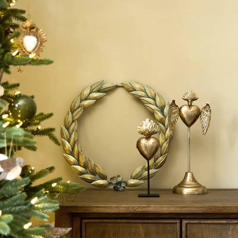 Decorative wreath on a wooden cabinet with Christmas tree and heart-shaped  figurines.