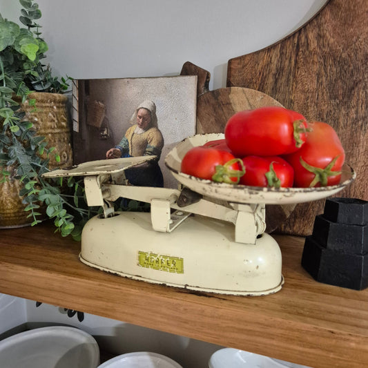 Vintage scales with tomatoes on a wooden surface
